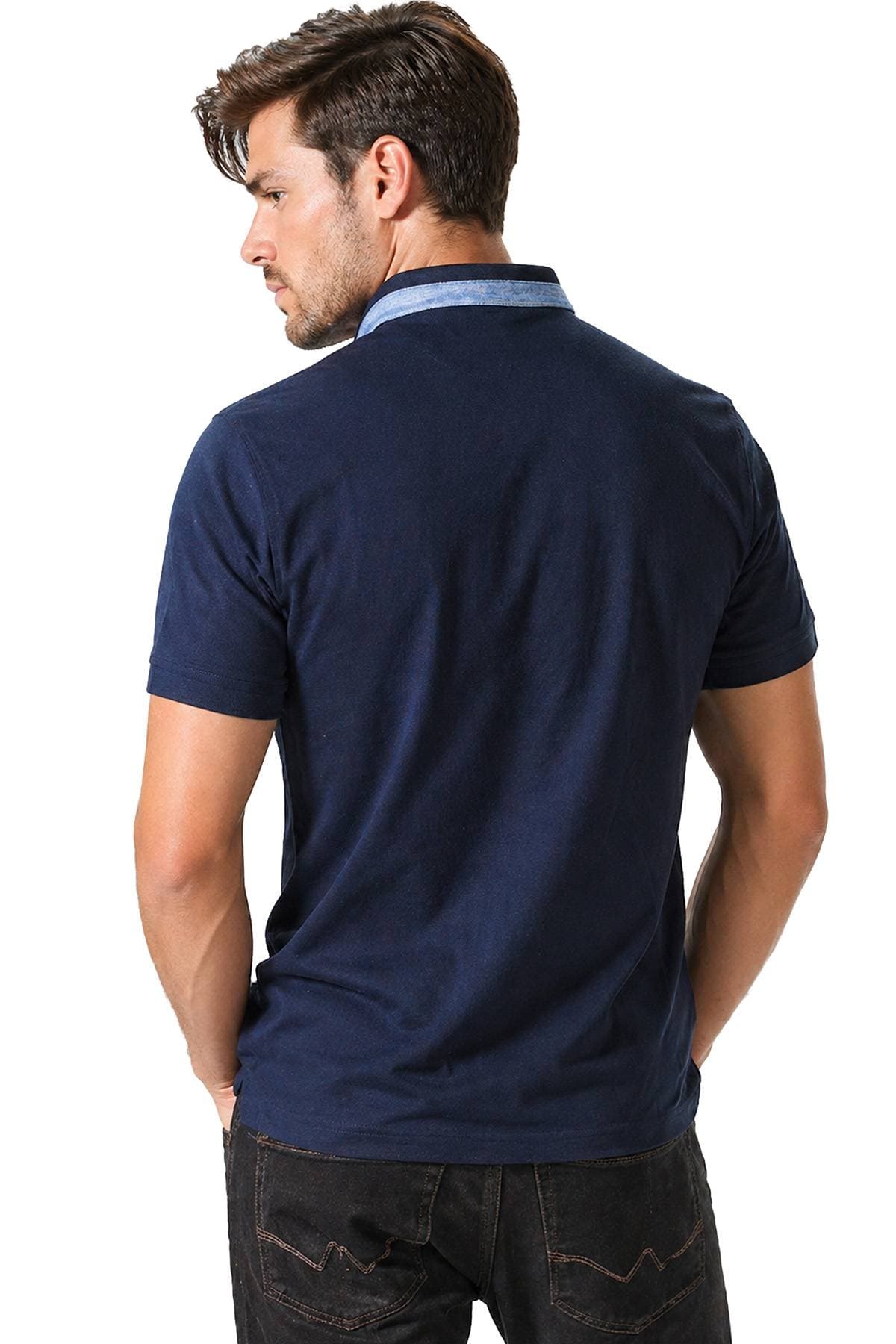 A man wearing a navy blue polo shirt with his back turned toward the camera.