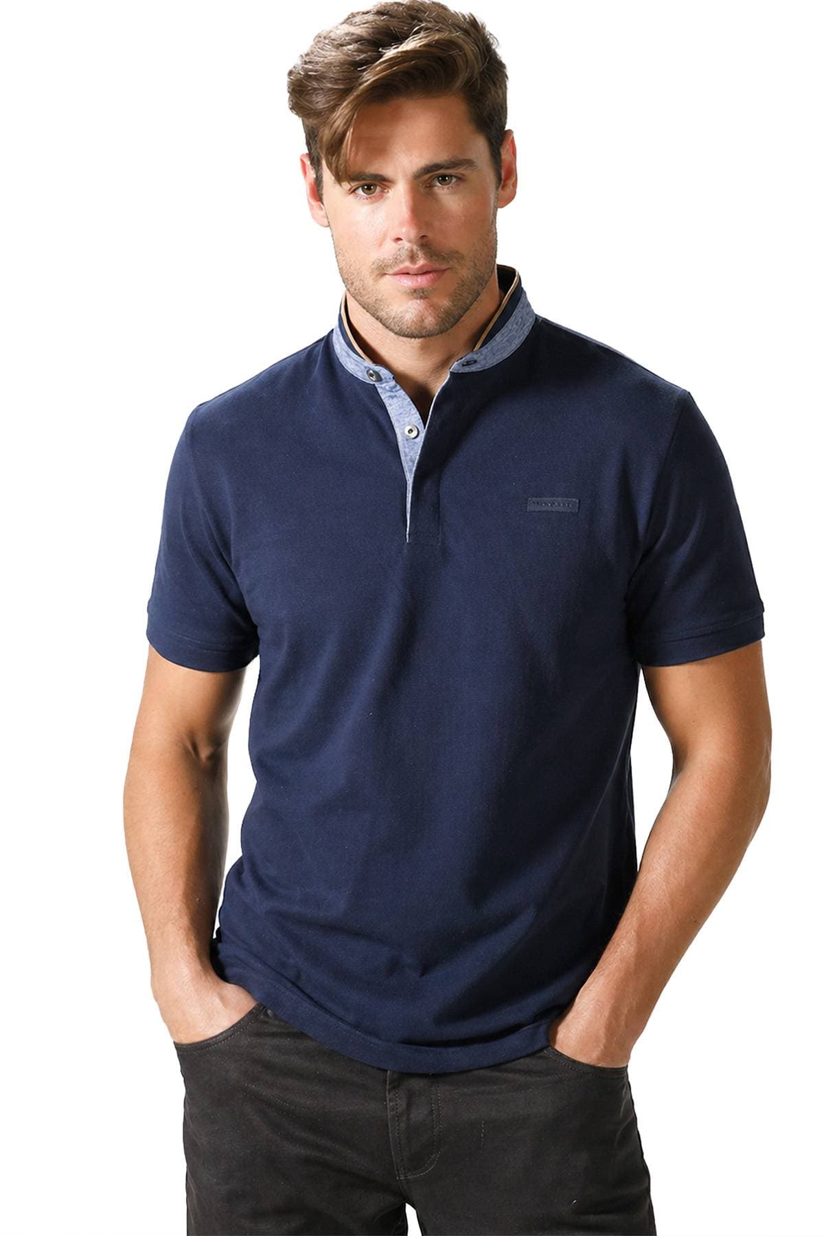 A man wearing a navy blue polo shirt with a partially unbuttoned collar.