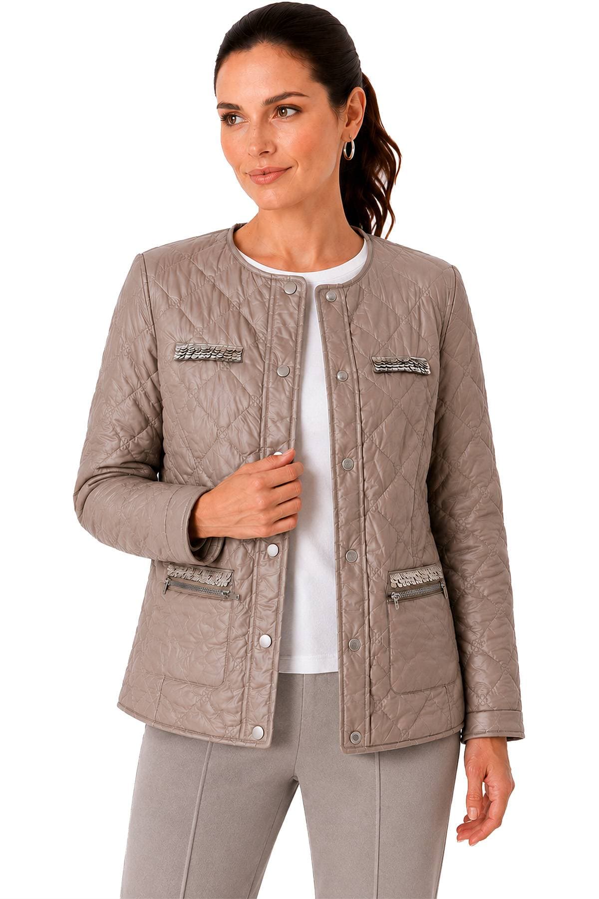 A person wearing a light brown quilted jacket with decorative pockets over a white shirt and gray pants.