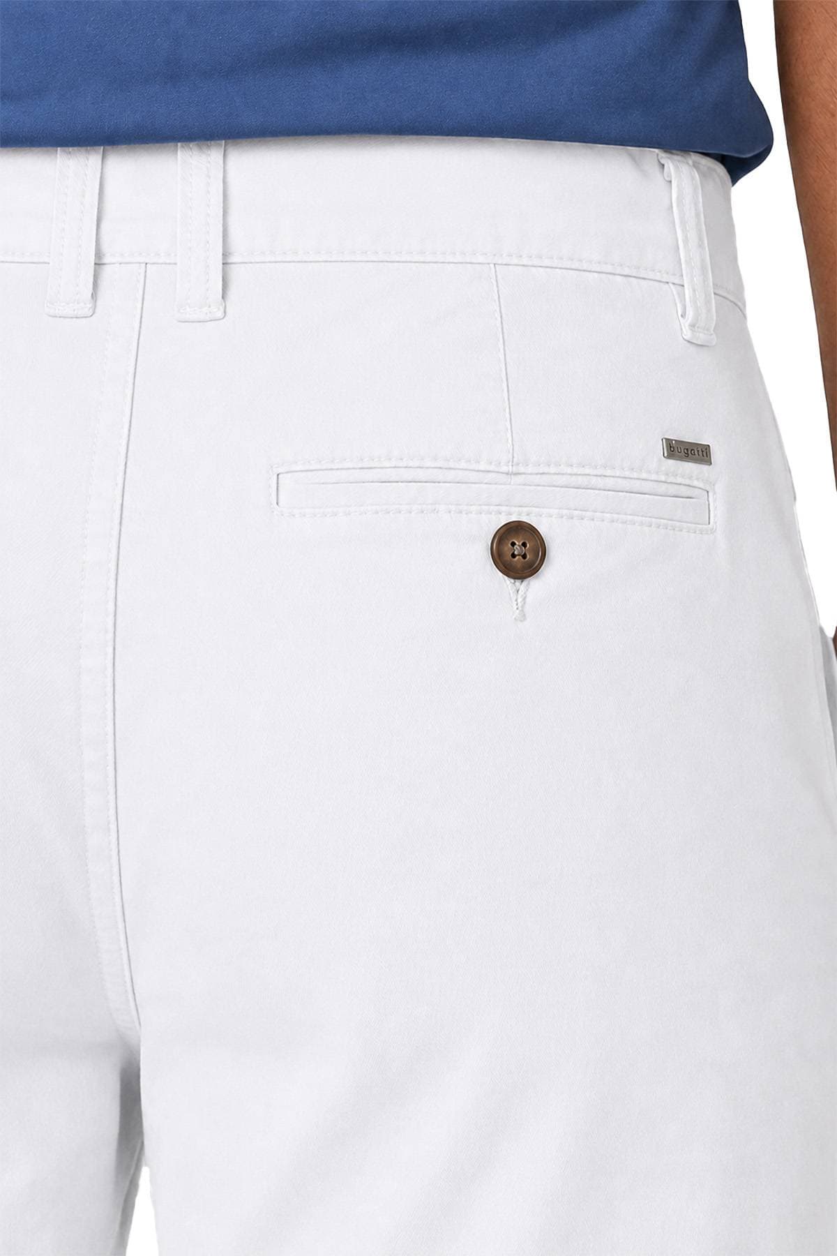 Close-up of the back pocket area of a pair of white pants with a button and a small metal brand tag.