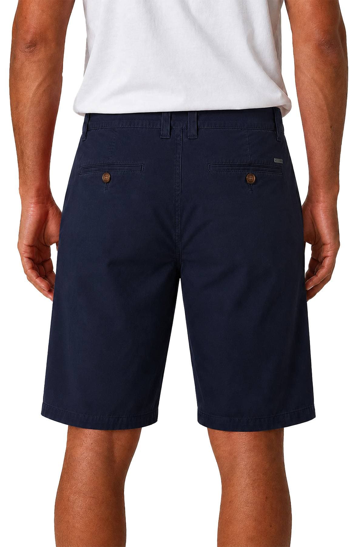 A person wearing a white shirt and dark blue shorts is shown from the back.