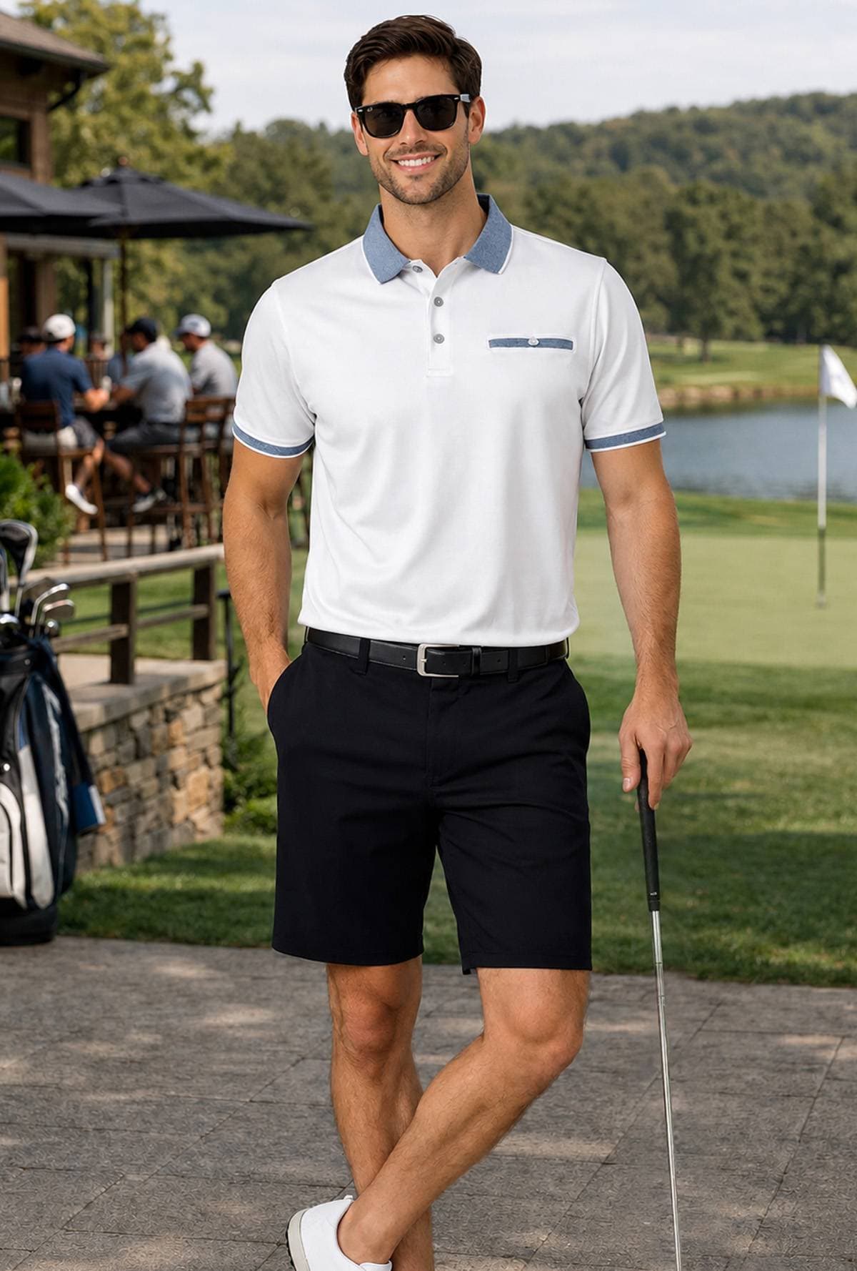 A man in sunglasses and a white polo shirt stands holding a golf club.