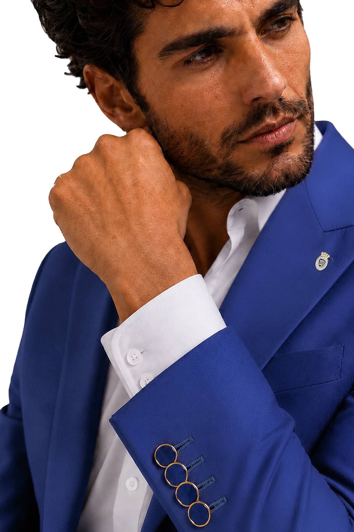 A man in a blue suit with gold buttons on the sleeve poses thoughtfully.