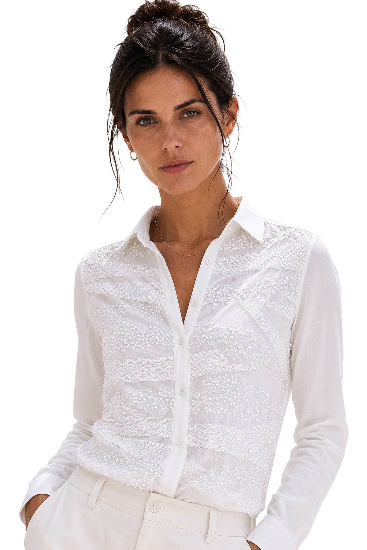 A person wearing a white long-sleeved shirt with intricate lace details.