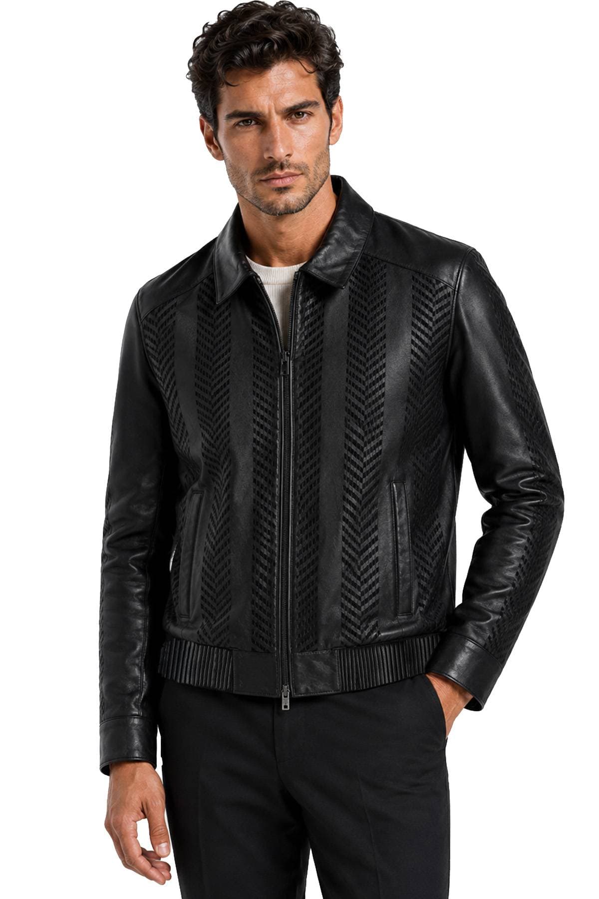 A man wearing a black leather jacket with a textured pattern stands with one hand in his pocket.