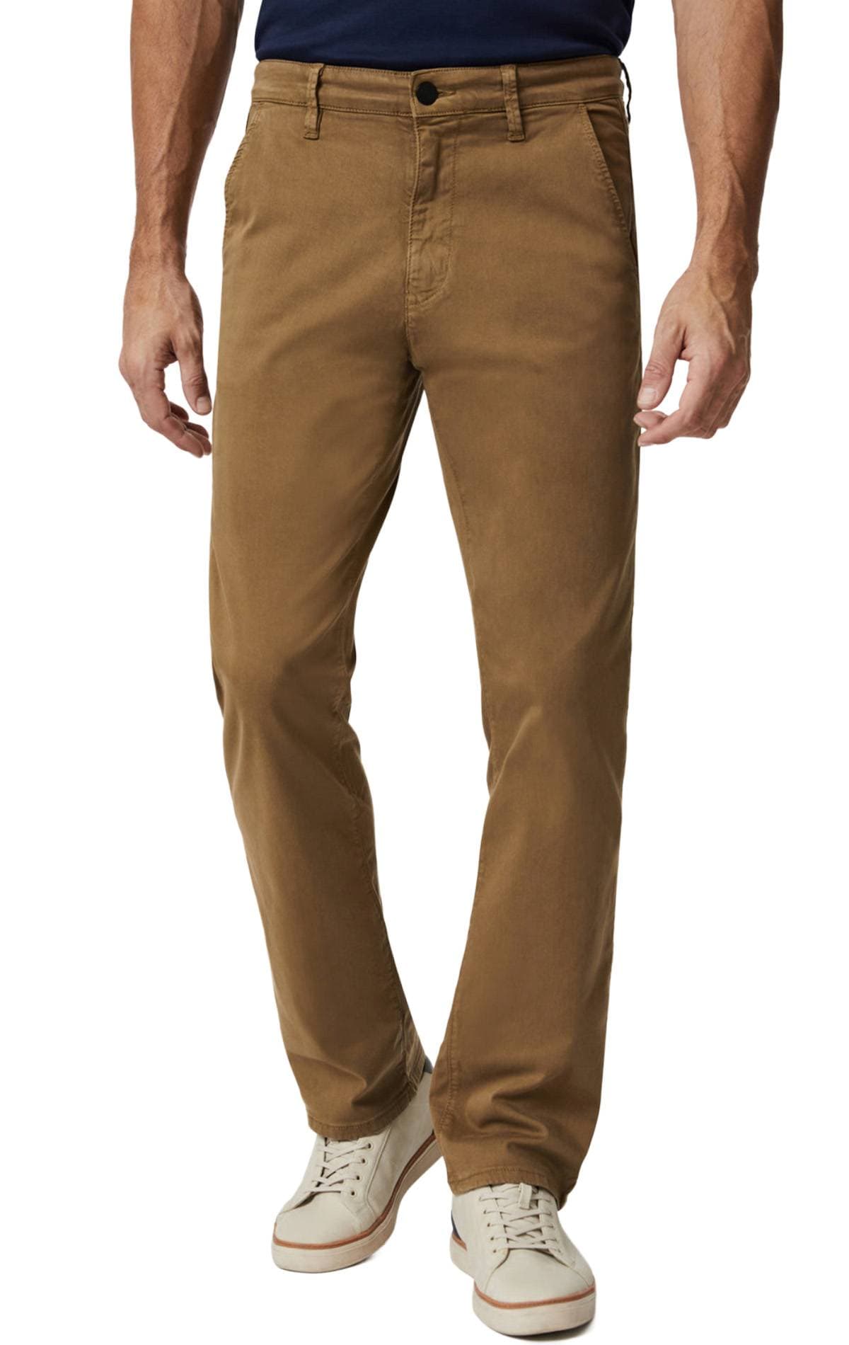 A person wearing brown pants and white sneakers.