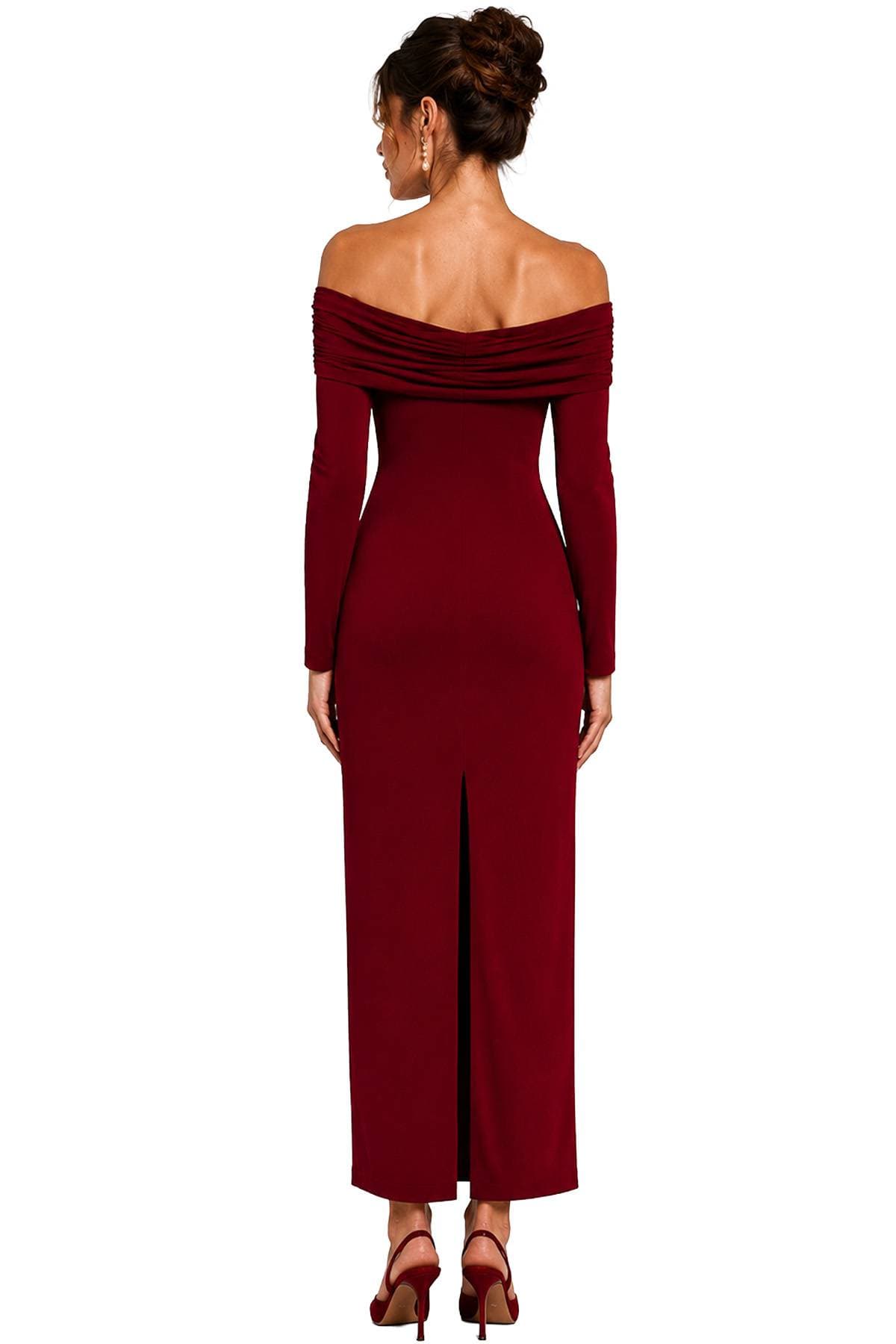 A woman in an off-the-shoulder burgundy dress stands facing away, showcasing her updo hairstyle and matching high heels.