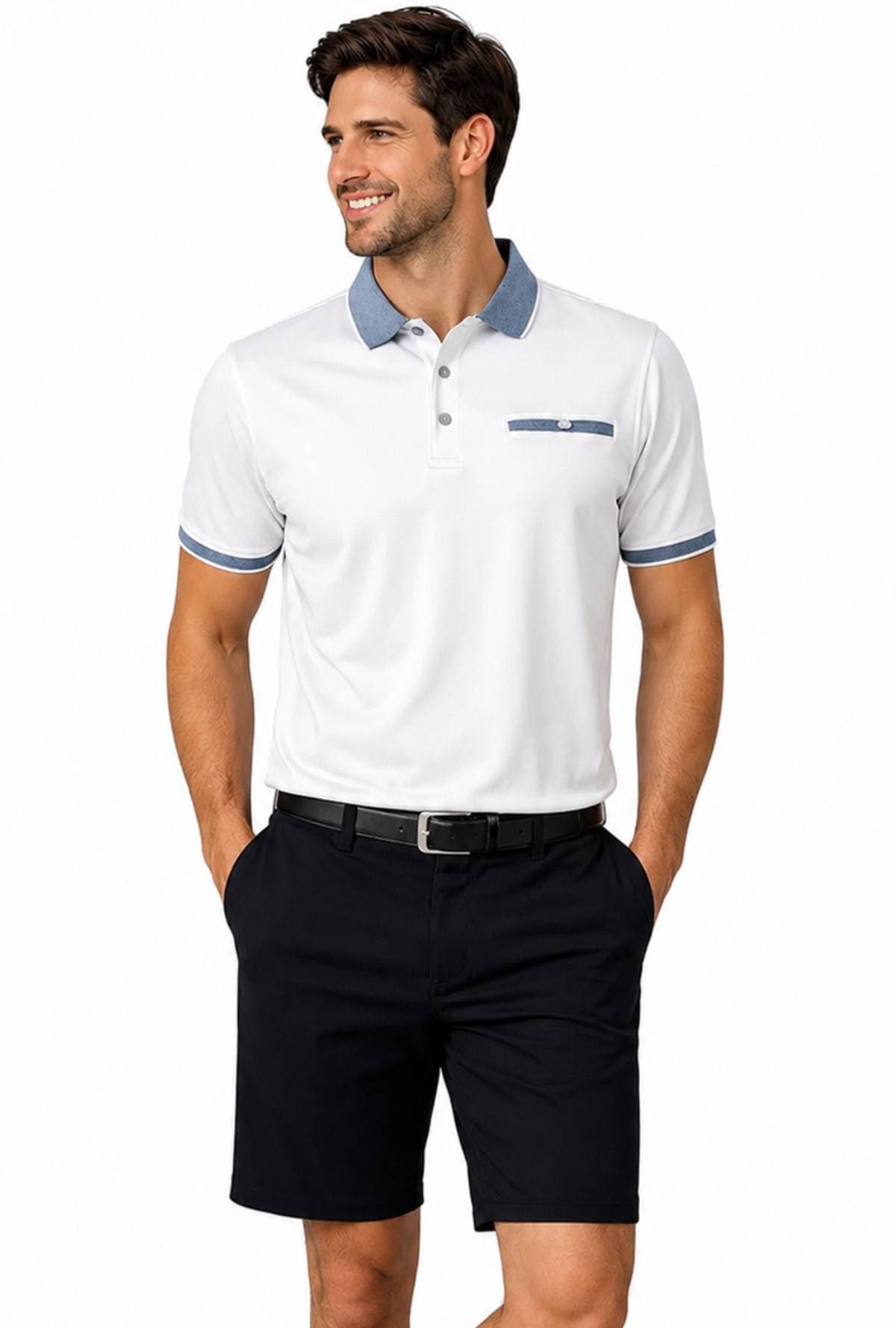 A man is wearing a white polo shirt and black shorts with his hands in his pockets.