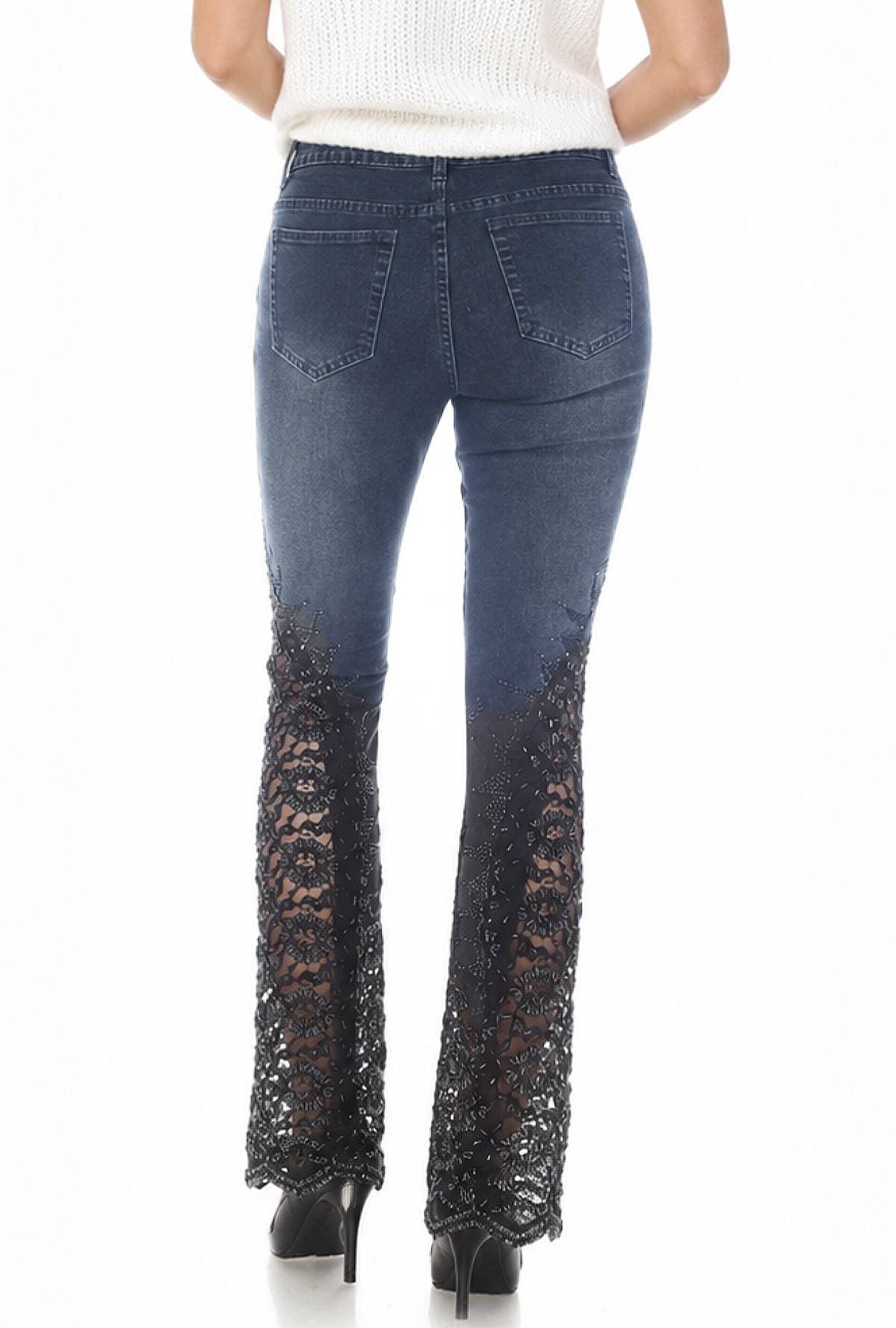 A person is wearing blue jeans with lace detailing at the lower legs and black high heels.