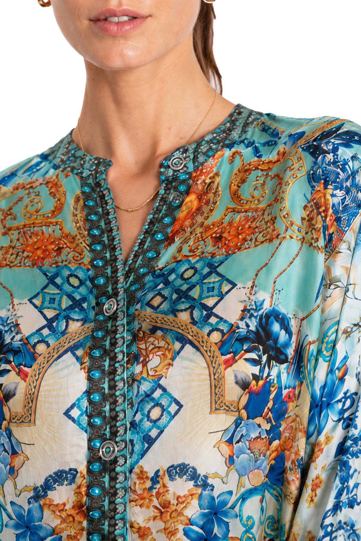 A person wearing a colorful patterned shirt with a detailed design.