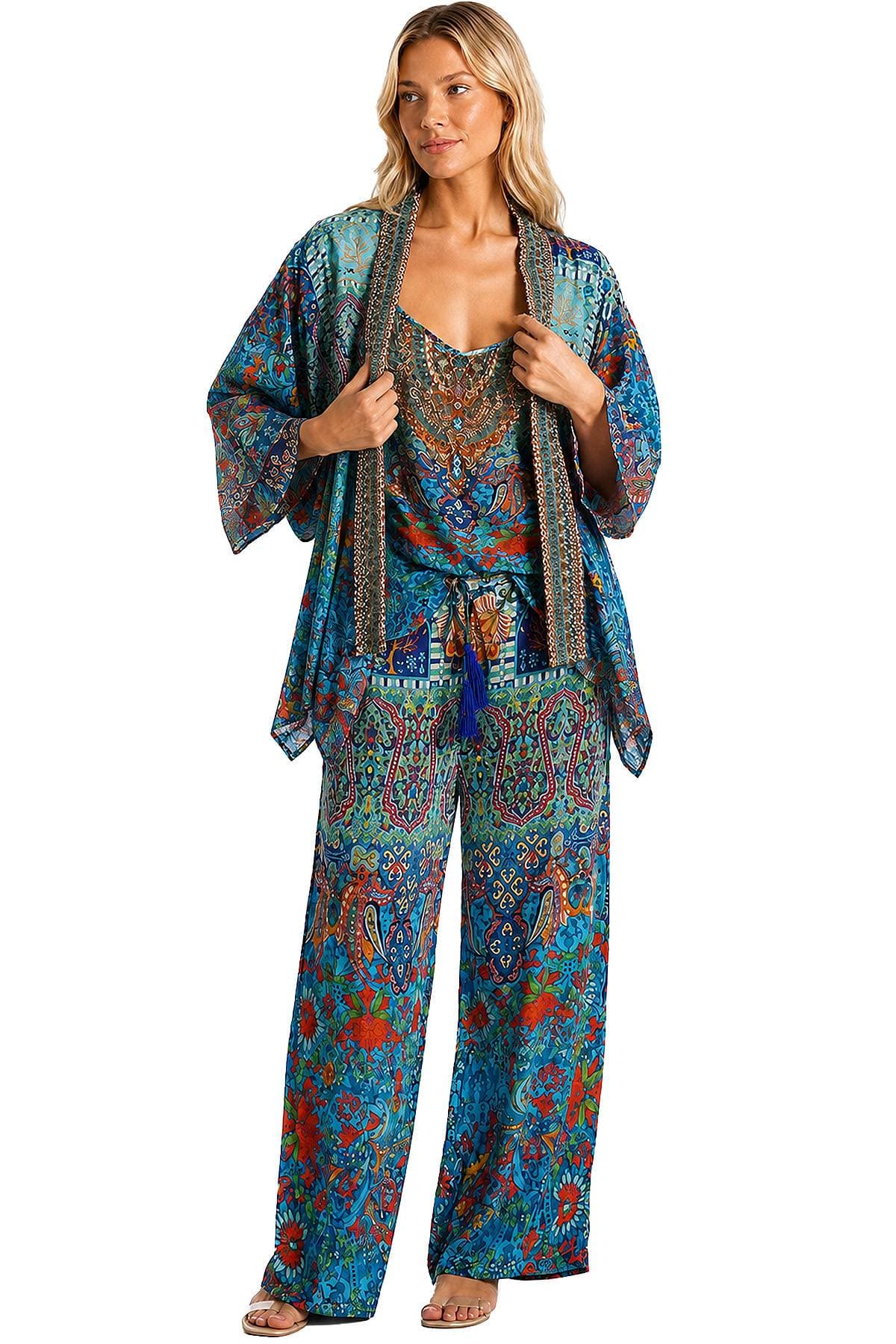 A person wearing a colorful, patterned kimono-style outfit stands with a relaxed posture.