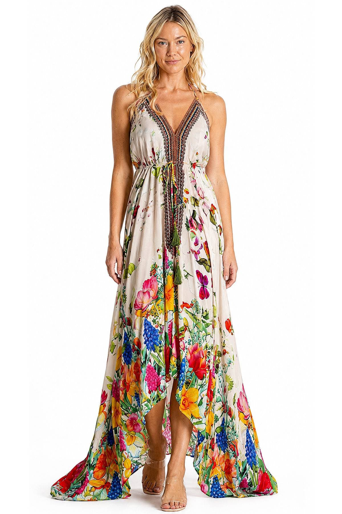 A woman wearing a long floral dress with a V-neck and colorful patterns.