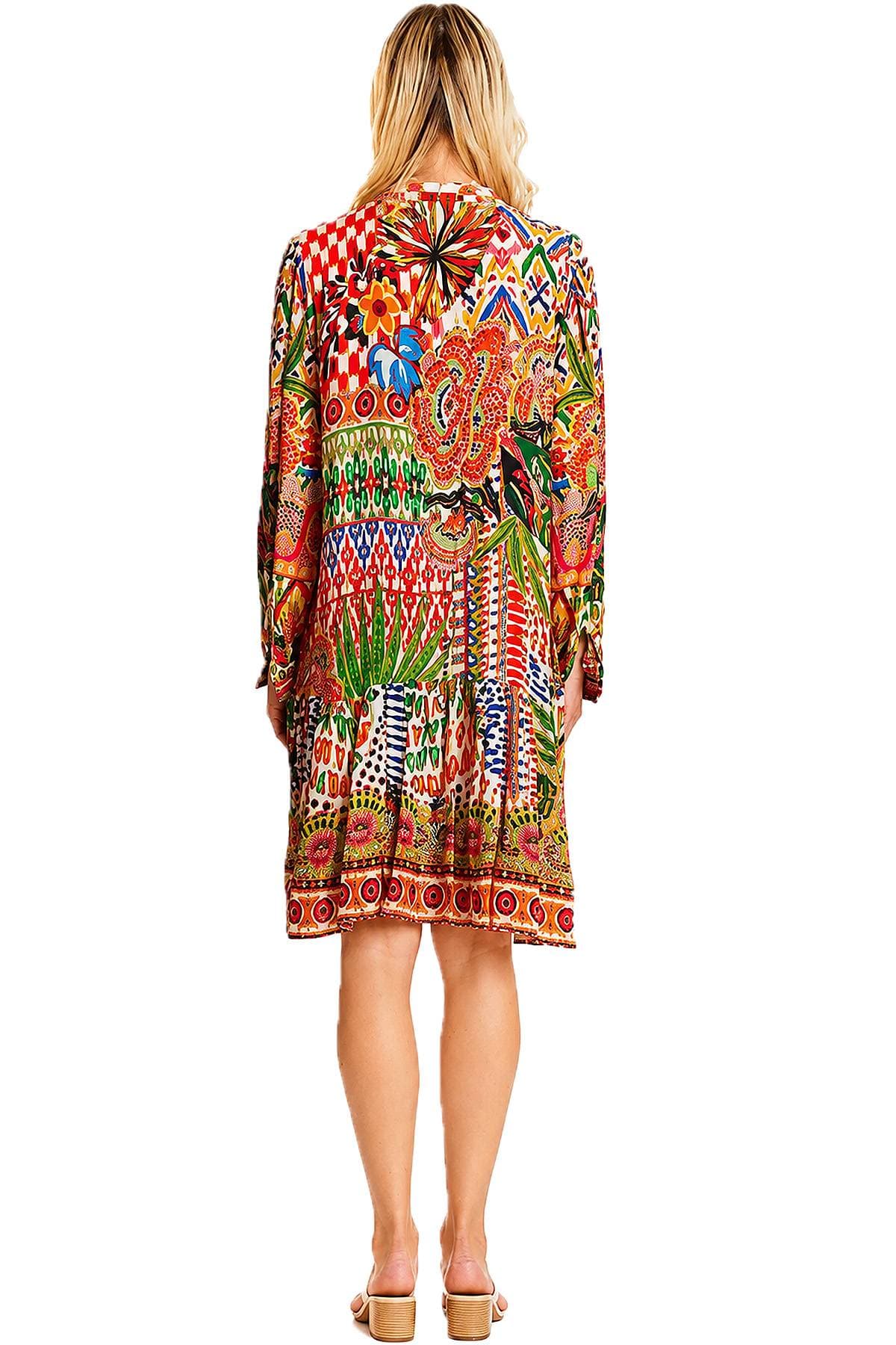 A person wearing a colorful, patterned dress is standing with their back to the camera.