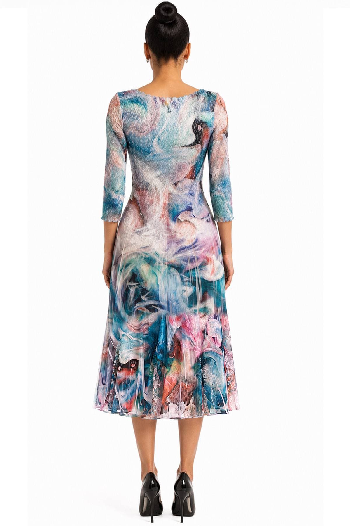 A woman wearing a colorful, abstract-patterned dress with three-quarter sleeves is shown from the back.