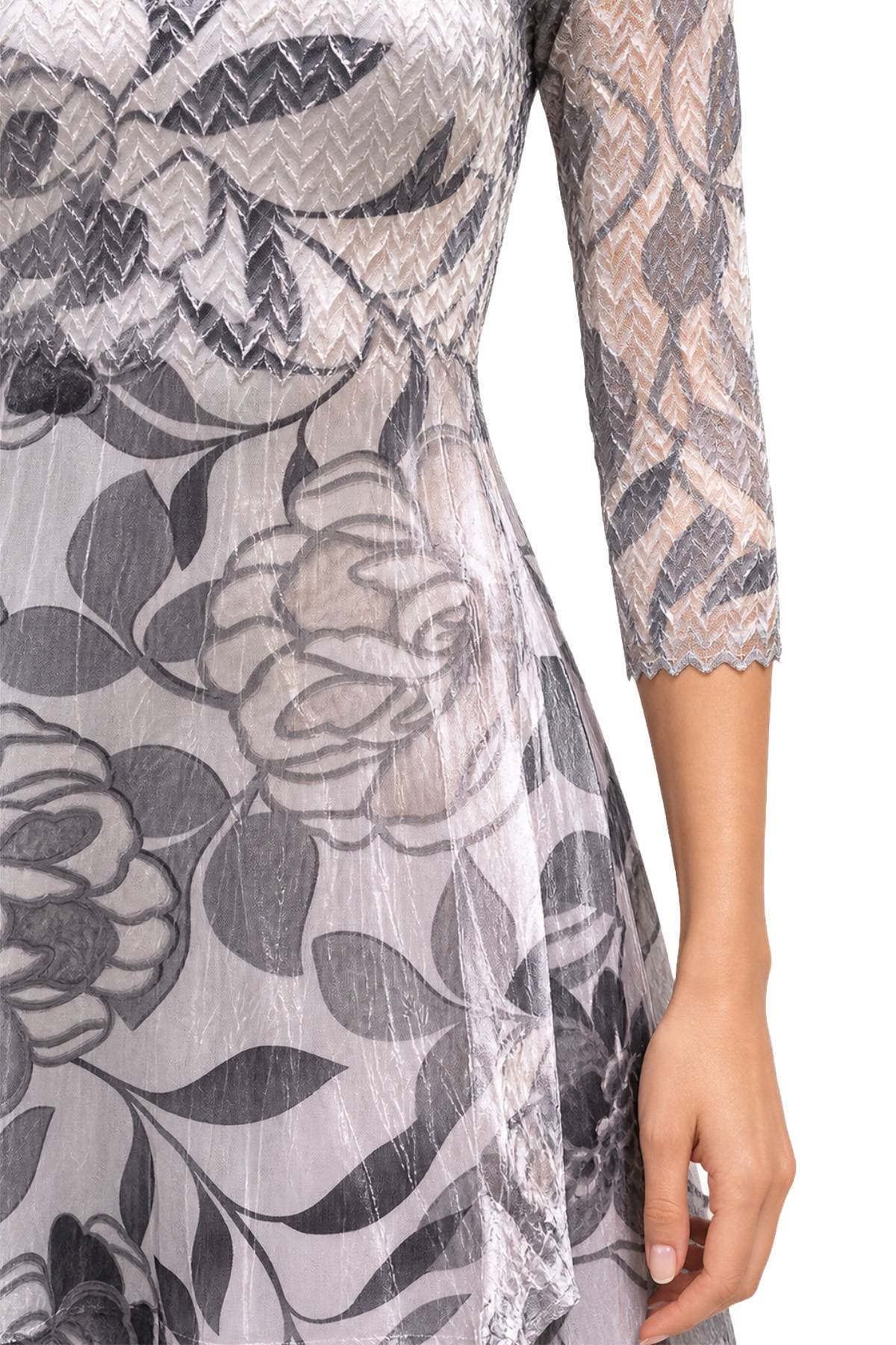 Close-up of Komarov illusion neck dress showing chevron lace detail and floral charmeuse print