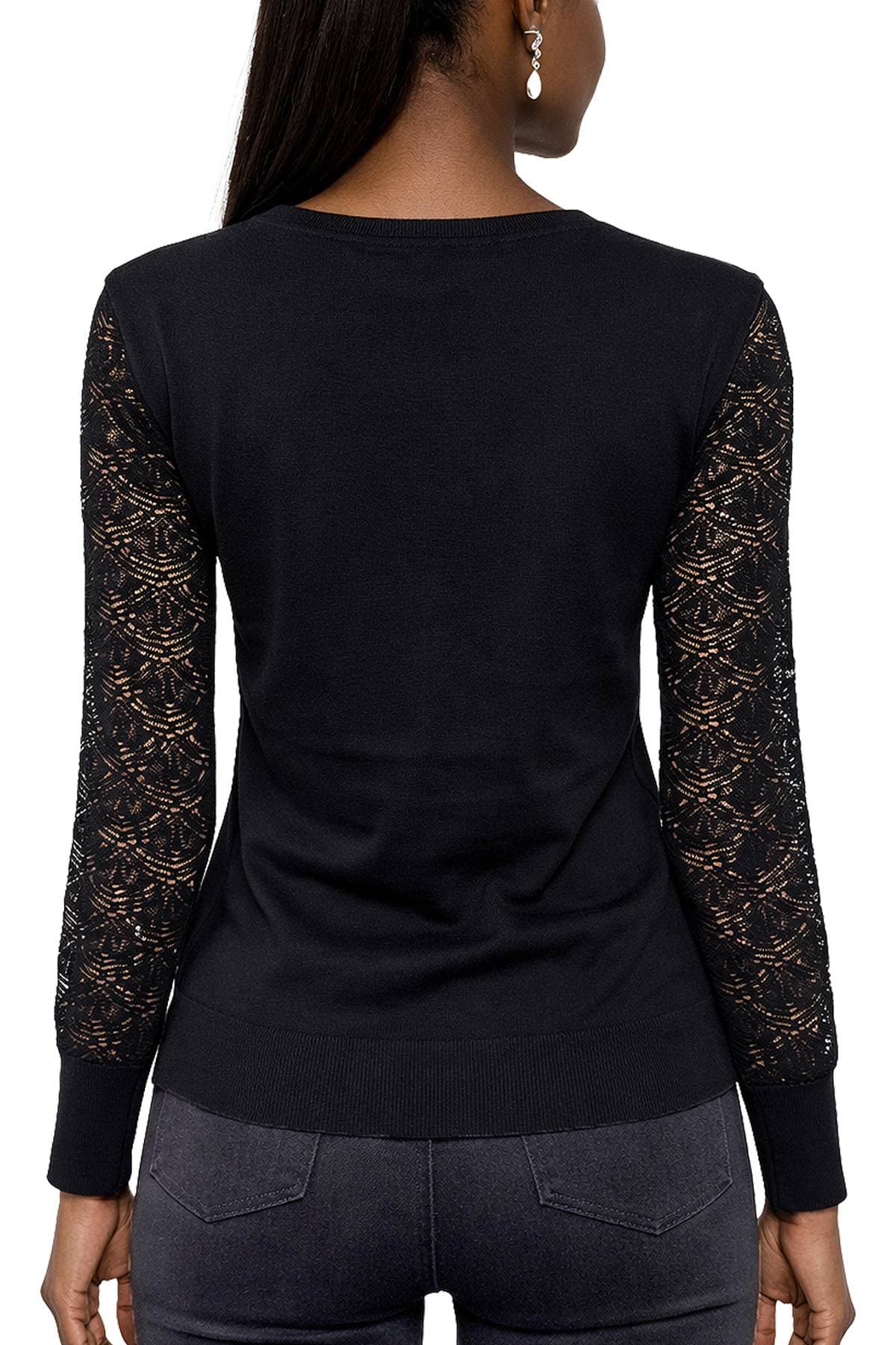 A person wearing a black top with lace sleeves and dark jeans, viewed from the back.