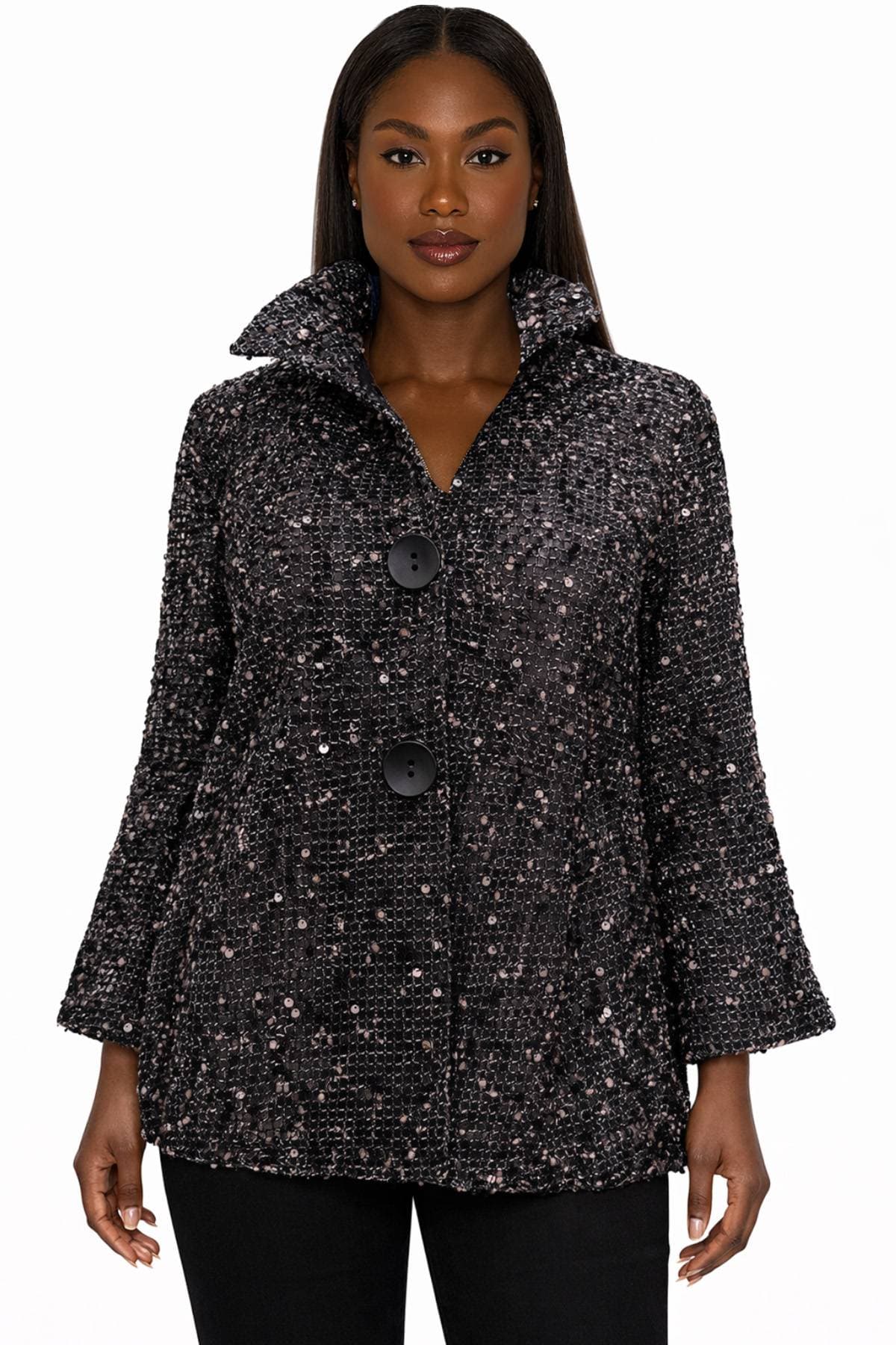A woman wearing a textured black coat with large buttons.
