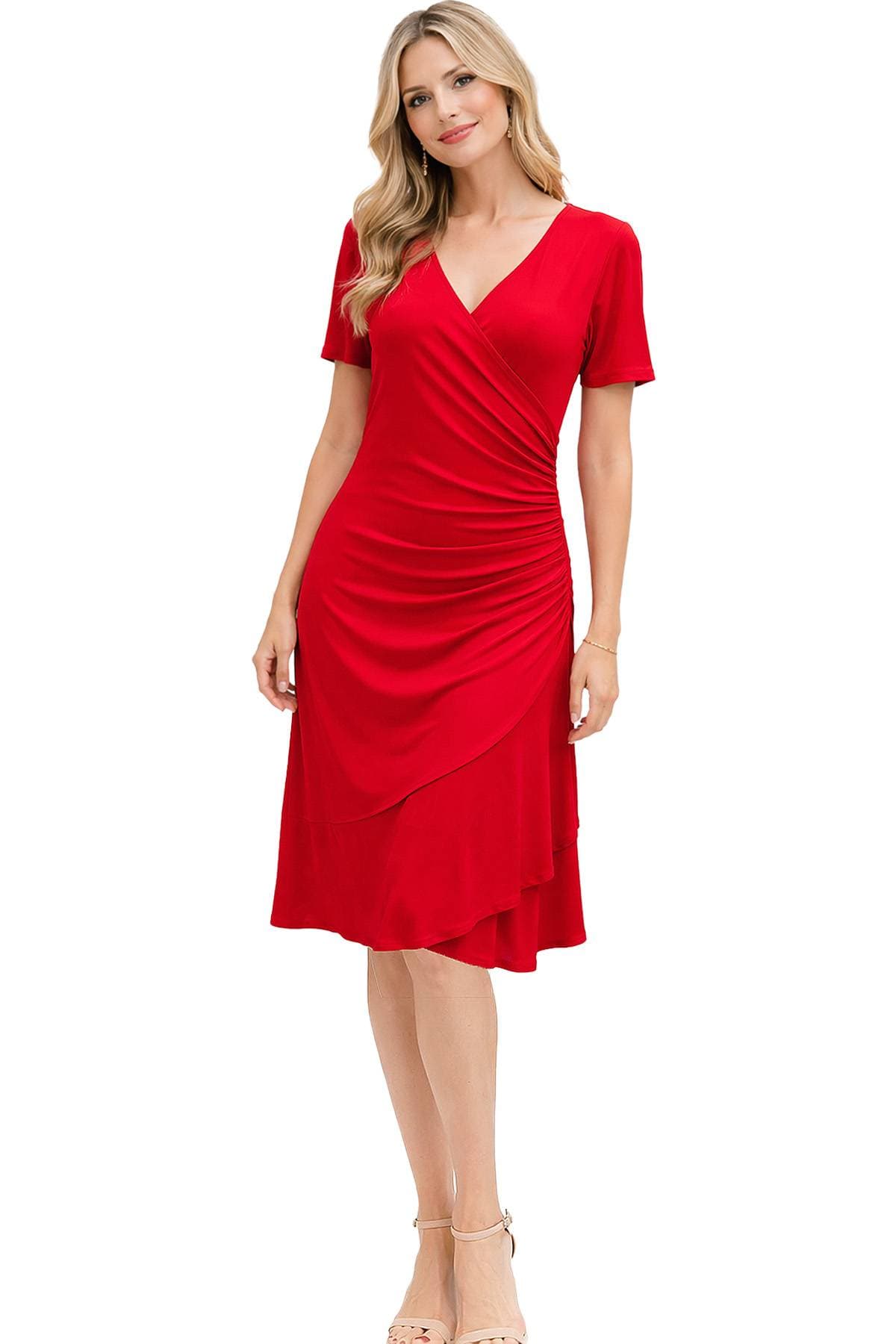 A woman wearing a red wrap dress with short sleeves and beige heels.