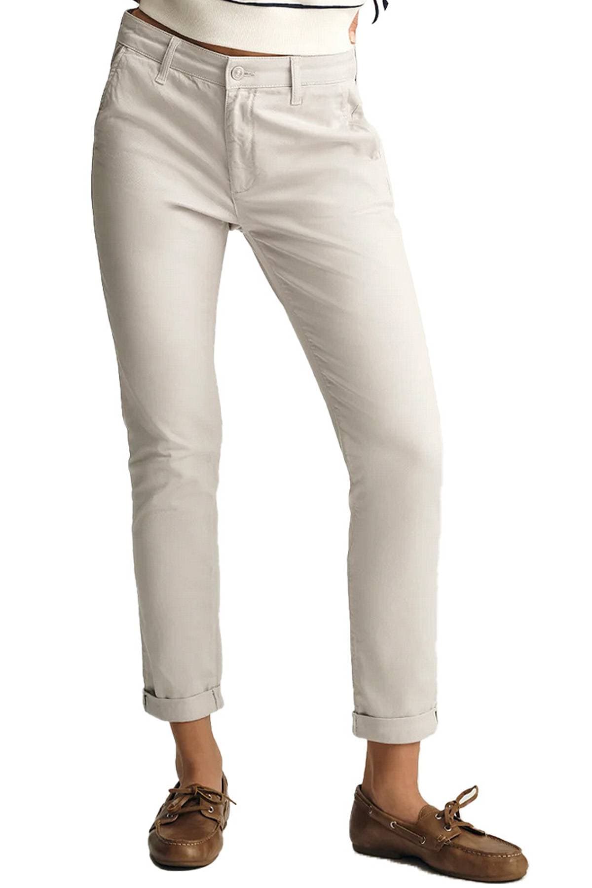A person wearing light-colored chinos and brown boat shoes.
