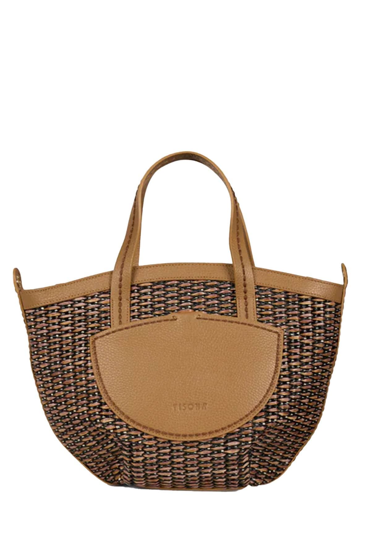 A woven handbag with tan leather handles and trim.