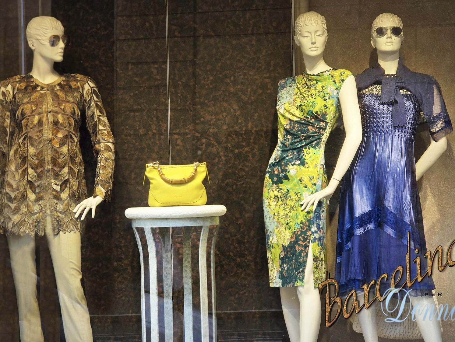 Women's store exterior with sale signage and merchandise displays