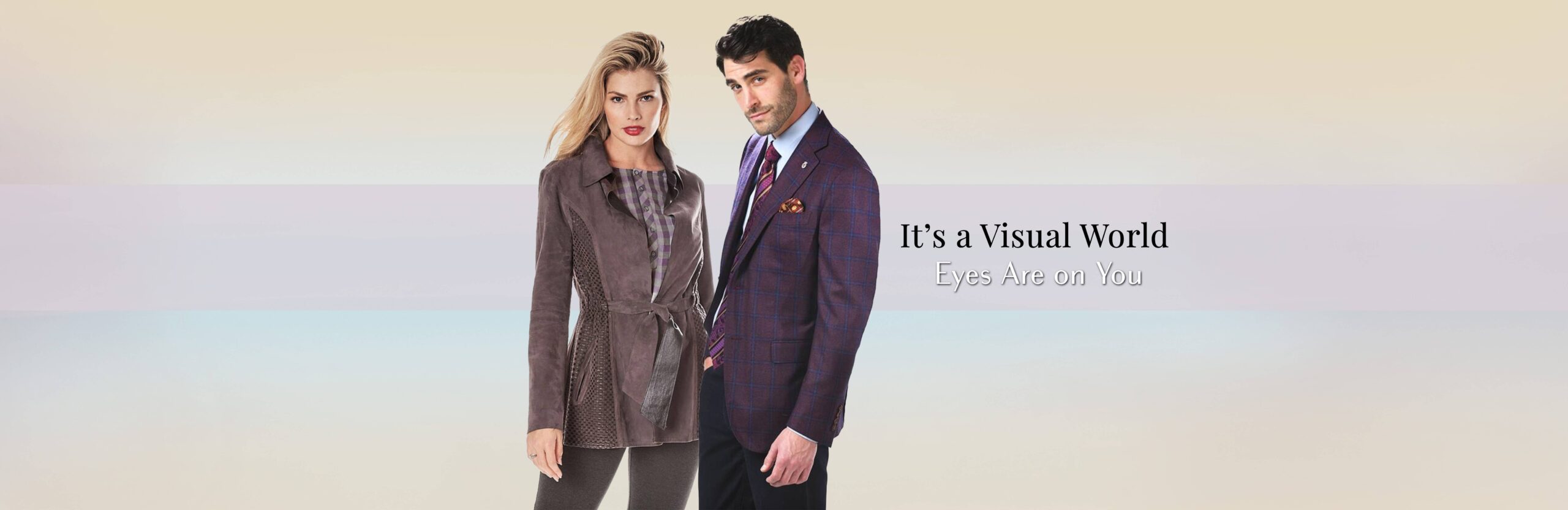 Man and woman wearing elegant fall fashion in front of a soft pastel background with the text “It’s a Visual World – Eyes Are on You” displayed beside them.